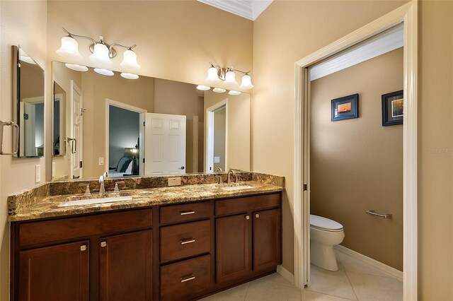 1053 Alcove Loop, The Villages, FL 32162 - bathroom featuring toilet, double vanity, connected bathroom, crown molding, and tile patterned floors