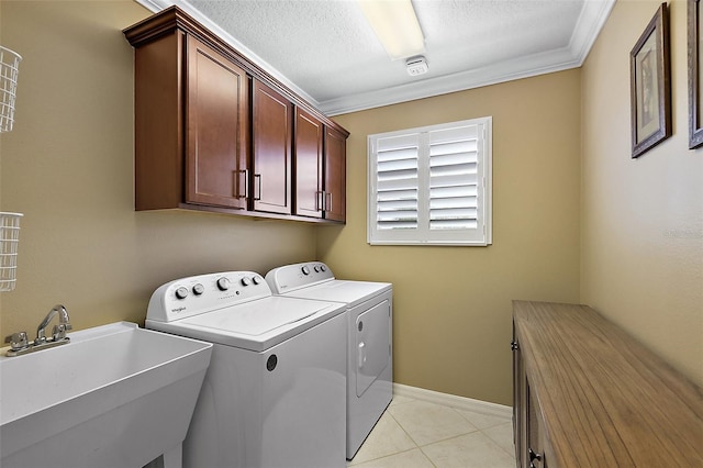 1053 Alcove Loop, The Villages, FL 32162 - clothes washing area featuring washing machine and dryer, cabinet space, a textured ceiling, crown molding, and light tile patterned flooring