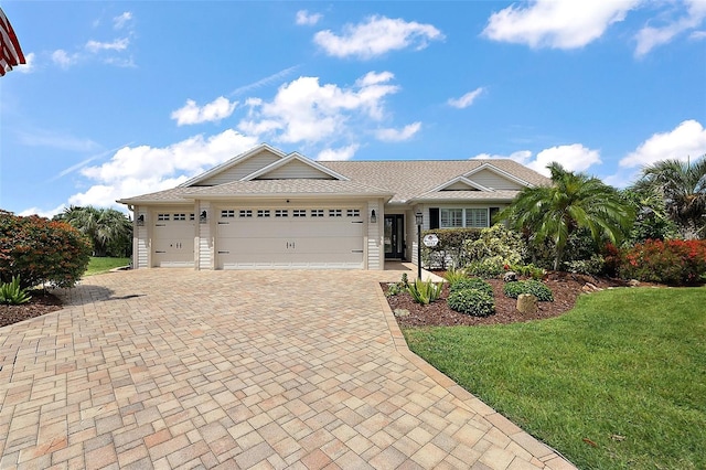 1053 Alcove Loop, The Villages, FL 32162 - ranch-style home featuring decorative driveway, a garage, and a front lawn