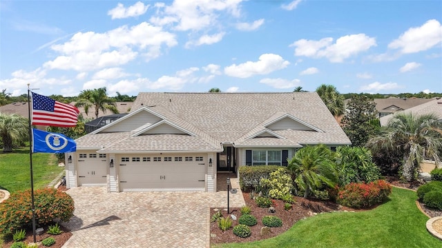 1053 Alcove Loop, The Villages, FL 32162 - view of front of house with a garage, driveway, a shingled roof, and a front lawn