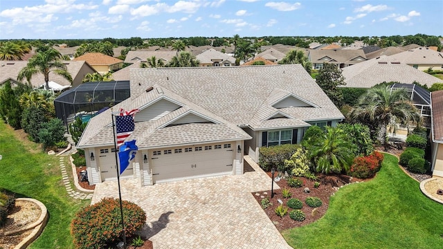 1053 Alcove Loop, The Villages, FL 32162 - view of front of property with an attached garage, driveway, roof with shingles, and a residential view