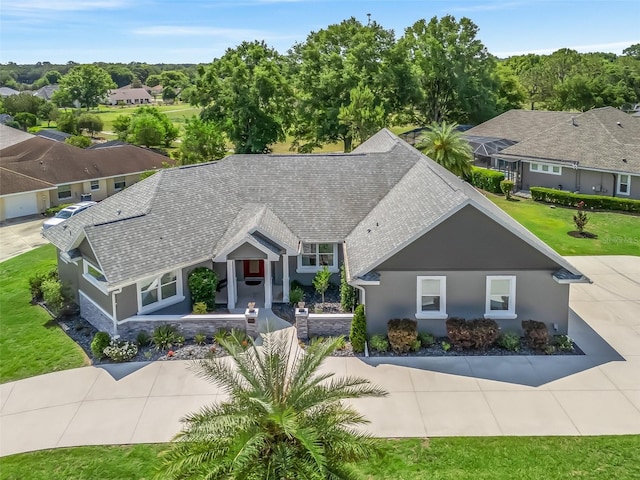 563 Dowling Cir, Lady Lake, FL 32159 - view of front of home with stucco siding and a shingled roof