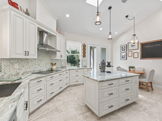 563 Dowling Cir, Lady Lake, FL 32159 - kitchen with wall chimney range hood, black electric stovetop, light marble finish flooring, tasteful backsplash, and recessed lighting