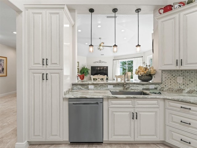 563 Dowling Cir, Lady Lake, FL 32159 - kitchen featuring stainless steel dishwasher, a sink, hanging light fixtures, and white cabinetry