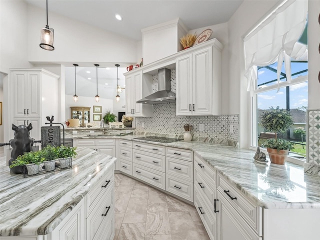 563 Dowling Cir, Lady Lake, FL 32159 - kitchen featuring wall chimney range hood, white cabinetry, a peninsula, tasteful backsplash, and black electric stovetop