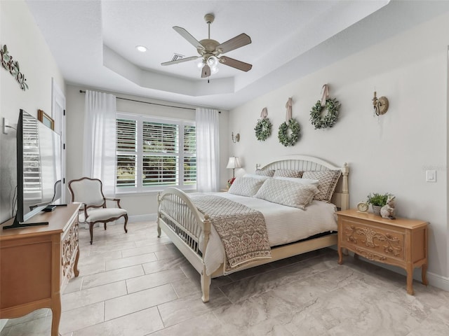 563 Dowling Cir, Lady Lake, FL 32159 - bedroom with a tray ceiling, baseboards, and ceiling fan