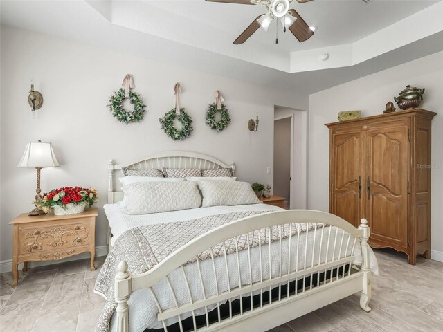 563 Dowling Cir, Lady Lake, FL 32159 - bedroom with a raised ceiling, baseboards, and a ceiling fan
