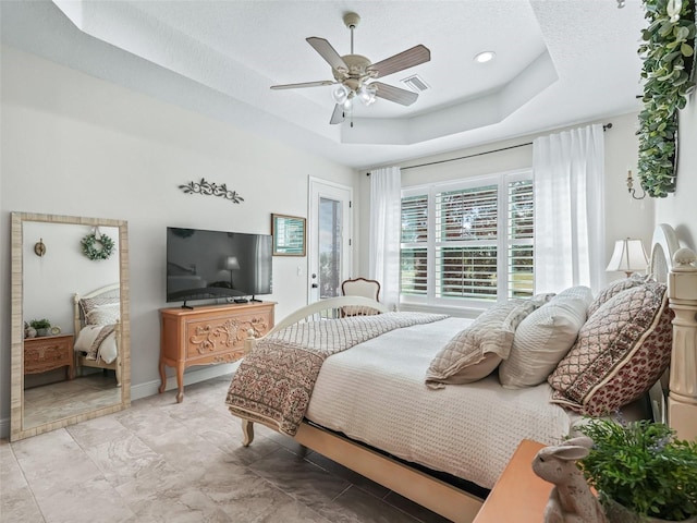 563 Dowling Cir, Lady Lake, FL 32159 - bedroom with a raised ceiling, ceiling fan, baseboards, and light marble finish floors