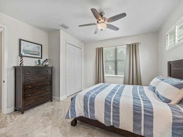 563 Dowling Cir, Lady Lake, FL 32159 - bedroom with a closet, a ceiling fan, and baseboards