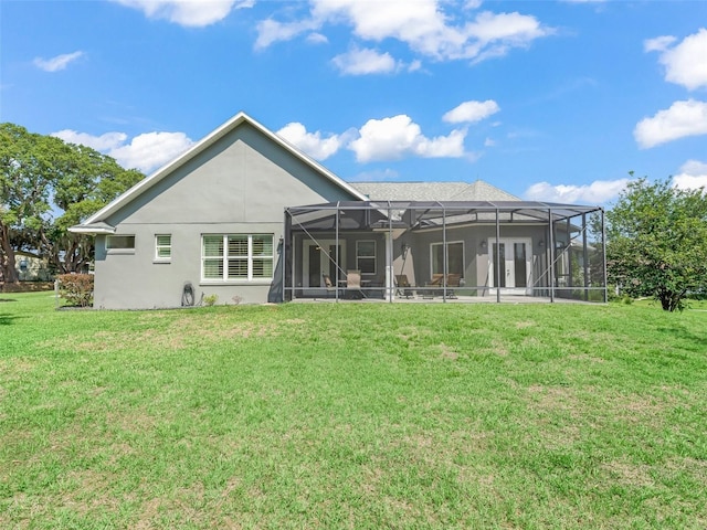563 Dowling Cir, Lady Lake, FL 32159 - back of property featuring a lawn, stucco siding, and a lanai