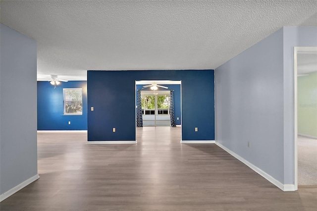 5618 Rosewall Cir, Leesburg, FL 34748 - unfurnished room with a ceiling fan, wood finished floors, a textured ceiling, and baseboards