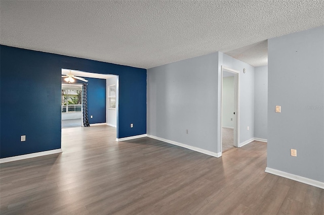 5618 Rosewall Cir, Leesburg, FL 34748 - empty room featuring wood finished floors, a textured ceiling, and baseboards