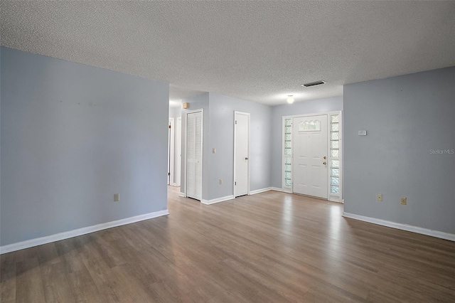 5618 Rosewall Cir, Leesburg, FL 34748 - unfurnished room with dark wood-style flooring, baseboards, and a textured ceiling