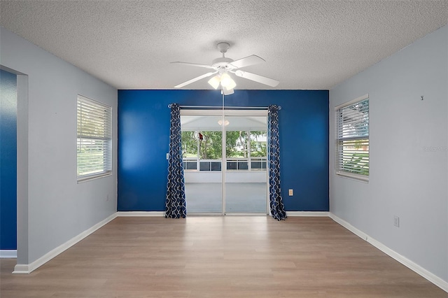 5618 Rosewall Cir, Leesburg, FL 34748 - spare room with wood finished floors, a textured ceiling, ceiling fan, healthy amount of natural light, and baseboards