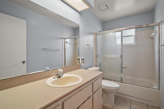 5618 Rosewall Cir, Leesburg, FL 34748 - bathroom with toilet, tile patterned flooring, vanity, and shower / bath combination with glass door