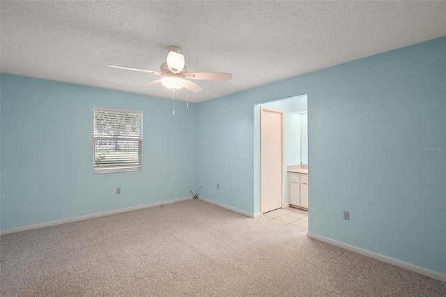 5618 Rosewall Cir, Leesburg, FL 34748 - unfurnished room with light colored carpet, a ceiling fan, baseboards, and a textured ceiling