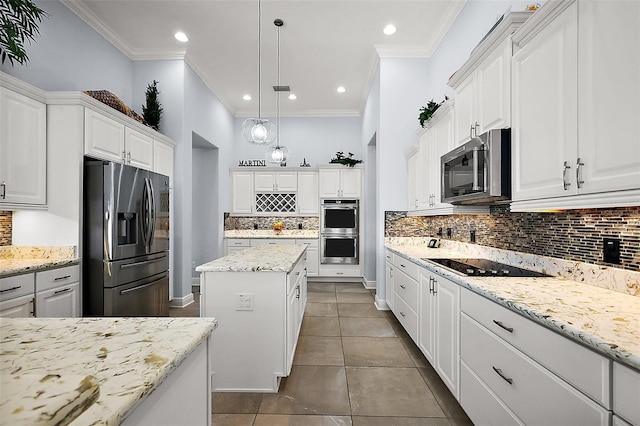 4033 Swaying Palm Ct, The Villages, FL 32163 - kitchen with stainless steel appliances, tasteful backsplash, ornamental molding, white cabinets, and hanging light fixtures