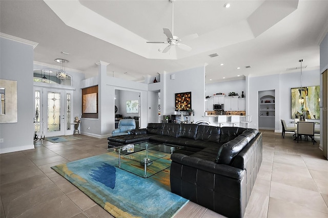 4033 Swaying Palm Ct, The Villages, FL 32163 - living room with a ceiling fan, a raised ceiling, light tile patterned flooring, baseboards, and crown molding