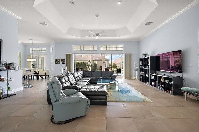 4033 Swaying Palm Ct, The Villages, FL 32163 - living area with a raised ceiling, tile patterned flooring, a ceiling fan, crown molding, and baseboards