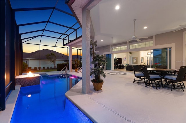 4033 Swaying Palm Ct, The Villages, FL 32163 - pool at dusk featuring ceiling fan, a patio, an outdoor pool, a lanai, and outdoor dining space
