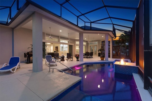 4033 Swaying Palm Ct, The Villages, FL 32163 - swimming pool with ceiling fan, a patio area, and glass enclosure