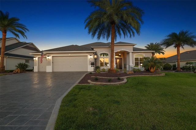 4033 Swaying Palm Ct, The Villages, FL 32163 - mediterranean / spanish-style house featuring a garage, stucco siding, concrete driveway, and a yard