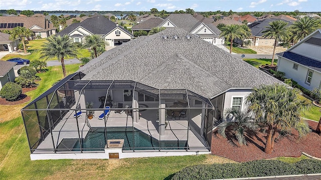 4033 Swaying Palm Ct, The Villages, FL 32163 - rear view of property with a patio, a residential view, an outdoor pool, glass enclosure, and a yard