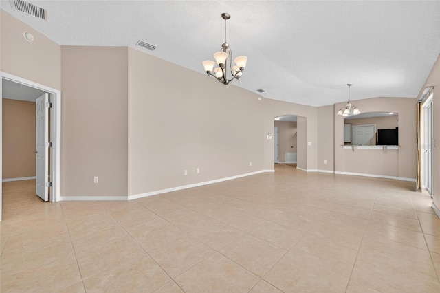 2744 Gresham Ave, The Villages, FL 32162 - unfurnished living room featuring a chandelier, light tile patterned floors, arched walkways, baseboards, and vaulted ceiling