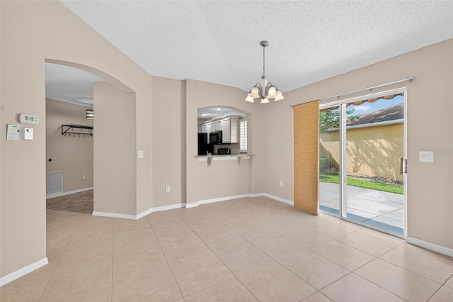 2744 Gresham Ave, The Villages, FL 32162 - tiled spare room with arched walkways, a chandelier, a textured ceiling, and baseboards