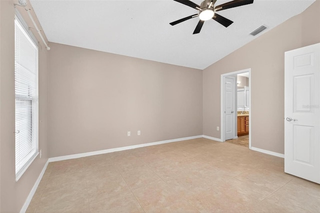 2744 Gresham Ave, The Villages, FL 32162 - unfurnished bedroom featuring lofted ceiling, light tile patterned floors, baseboards, ensuite bathroom, and a ceiling fan