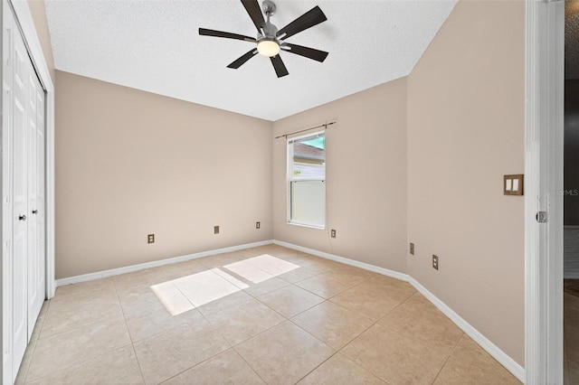 2744 Gresham Ave, The Villages, FL 32162 - unfurnished bedroom featuring light tile patterned flooring, a closet, baseboards, a ceiling fan, and a textured ceiling