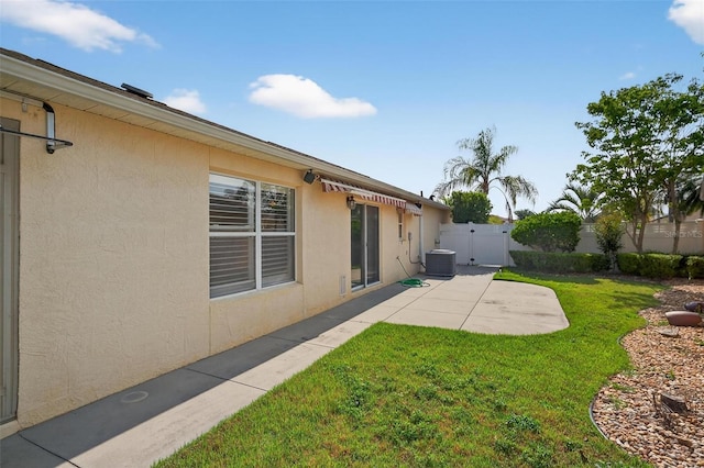 2744 Gresham Ave, The Villages, FL 32162 - view of yard with a patio, central air condition unit, and a gate
