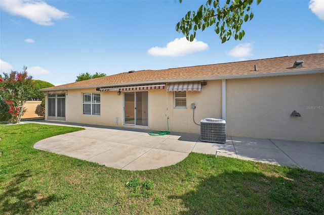 2744 Gresham Ave, The Villages, FL 32162 - rear view of property featuring cooling unit, stucco siding, a patio, and a lawn