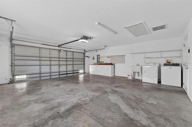 2744 Gresham Ave, The Villages, FL 32162 - garage with a garage door opener, washer and clothes dryer, and a sink