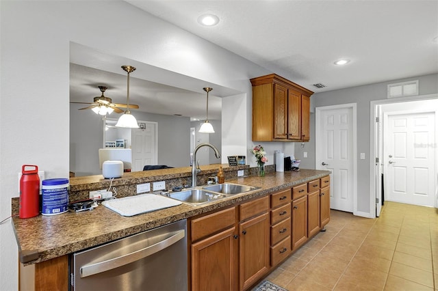 kitchen with dishwasher, a sink, dark countertops, brown cabinetry, and light tile patterned floors