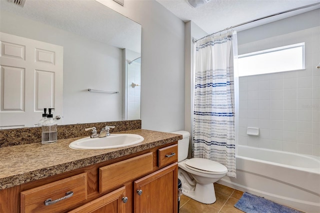 bathroom featuring toilet, tile patterned floors, vanity, shower / tub combo with curtain, and a textured ceiling