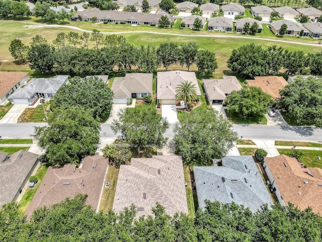 aerial view of property and surrounding area with nearby suburban area and a local golf course