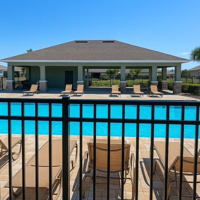 2106 Elio Ridge Dr, Zellwood, FL 32798 - community pool with a patio and fence