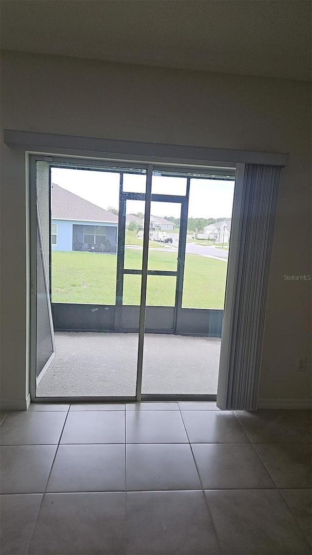 2106 Elio Ridge Dr, Zellwood, FL 32798 - doorway to outside featuring tile patterned floors and baseboards