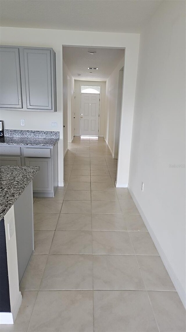 2106 Elio Ridge Dr, Zellwood, FL 32798 - hallway with light tile patterned floors and baseboards