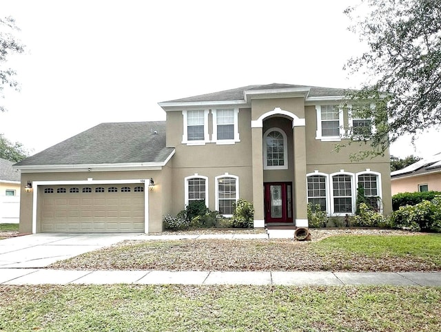 108 Whispering Pines Way, Davenport, FL 33837 - view of front of home with a garage, stucco siding, and concrete driveway