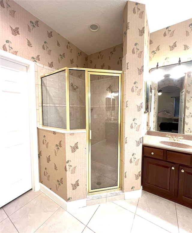 108 Whispering Pines Way, Davenport, FL 33837 - bathroom with a shower stall, tile patterned floors, wallpapered walls, baseboards, and vanity