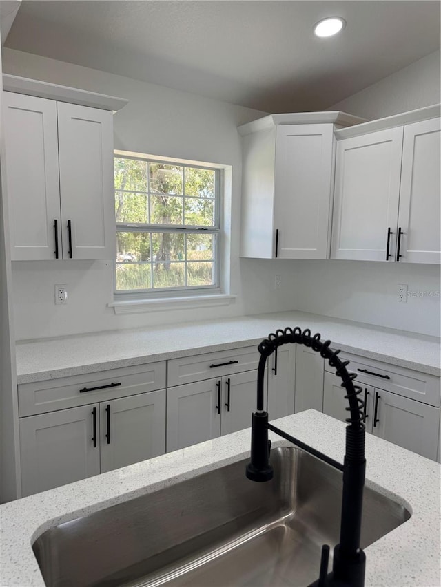 2 Pine Terrace Way, Ocala, FL 34472 - kitchen with white cabinetry, a sink, recessed lighting, and light stone counters