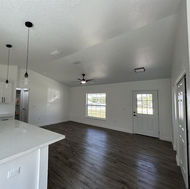 2 Pine Terrace Way, Ocala, FL 34472 - unfurnished living room featuring vaulted ceiling, a ceiling fan, baseboards, dark wood finished floors, and a textured ceiling