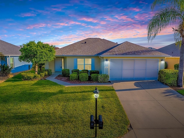 8601 SE 133rd St, Summerfield, FL 34491 - ranch-style house featuring an attached garage, stucco siding, driveway, a lawn, and roof with shingles
