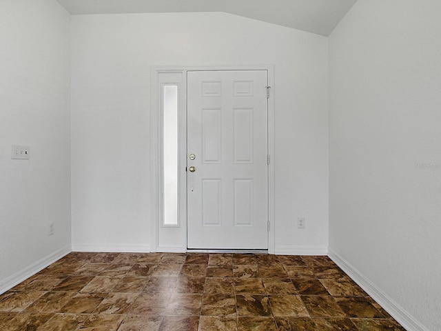 8601 SE 133rd St, Summerfield, FL 34491 - foyer entrance with lofted ceiling, baseboards, and dark stone finish floors