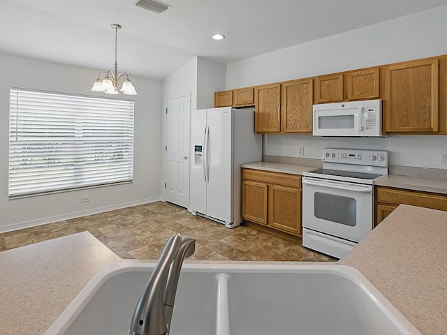 8601 SE 133rd St, Summerfield, FL 34491 - kitchen with white appliances, a chandelier, brown cabinetry, hanging light fixtures, and vaulted ceiling