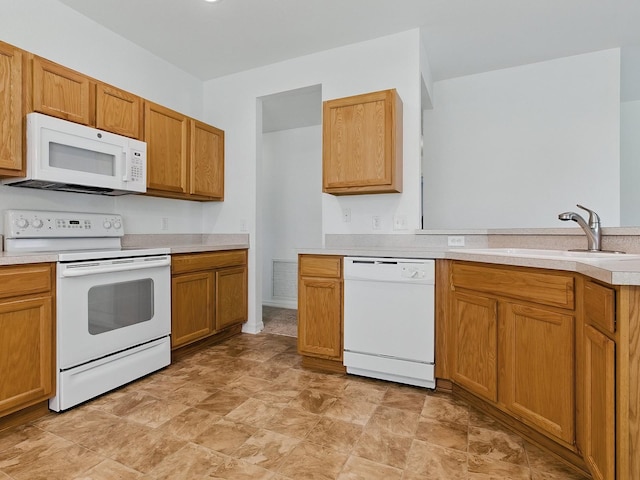 8601 SE 133rd St, Summerfield, FL 34491 - kitchen with white appliances, a sink, light countertops, stone finish flooring, and a peninsula