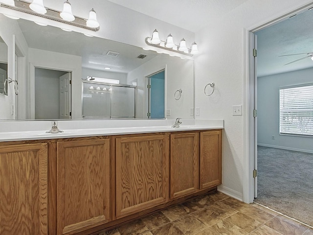 8601 SE 133rd St, Summerfield, FL 34491 - bathroom with a shower stall, double vanity, baseboards, and a ceiling fan