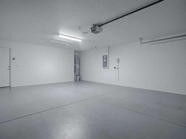 8601 SE 133rd St, Summerfield, FL 34491 - garage featuring electric panel, electric water heater, concrete block wall, and a garage door opener